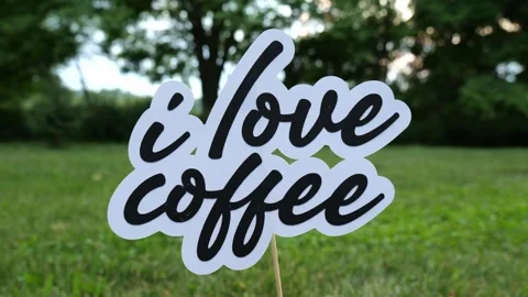 Message of the words I Love Coffee Outdoors in Nature at Dusk 4k Video Stock Video stock 317367987