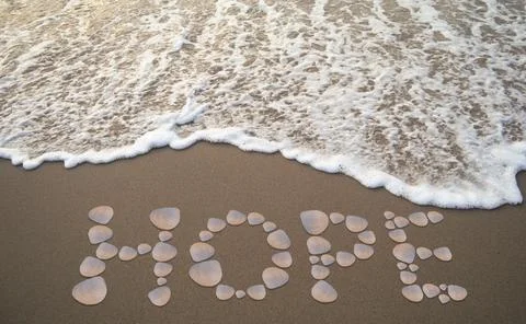 Message written with shells on the sand of the beach by the sea Stock Photos