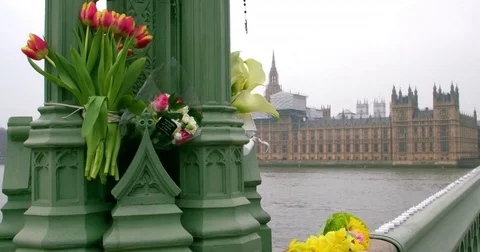 MESSAGES FLOWERS LEFT IN WESTMINSTER BRIDGE LONDON Stock Footage 80682035
