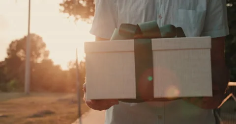 The messenger carries a box in a gift package Stock Footage 147327436