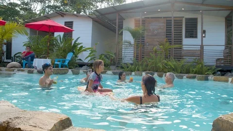 Messing around with people on the pool at an lodge in ecuador Video stock 116207572