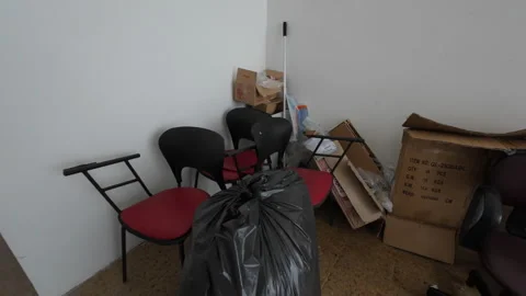 Messy abandoned office corner with garbage Видео 345172134