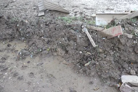 Messy Aftermath Scene with Mud, Debris, and Footprints Stock-Fotos
