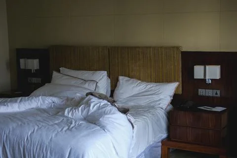 Messy bed after waking up early morning in a luxury hotel business suite Fotos de archivo