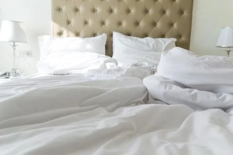Messy bedding sheets and pillow Stock Photos