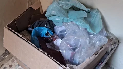 Messy cardboard box filled with plastic waste and garbage video footage Stock Footage 341770828
