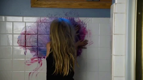 Messy Child Coloring with Paint on Wall at Home Stock Footage