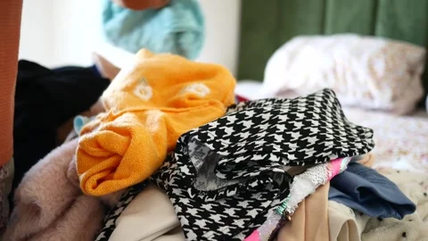 Messy clothes on a bed at home Stock Footage 271594462