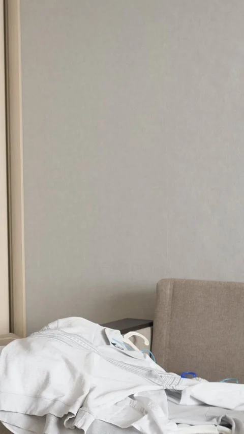 Messy clothes being thrown on a sofa, creating a pile of laundry. A concept of Stock-Footage 341580014