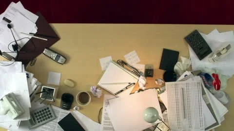 A messy desk is cleaned up Stock Footage