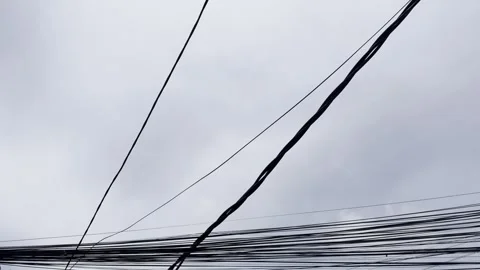 Messy Electrical Cables Against Cloudy Sky with Moving Clouds Video stock 332542674