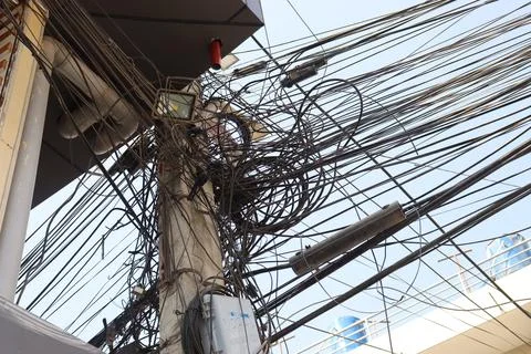 Messy electrical cables in Nepal example of uncovered optical fiber technology Stock Photos