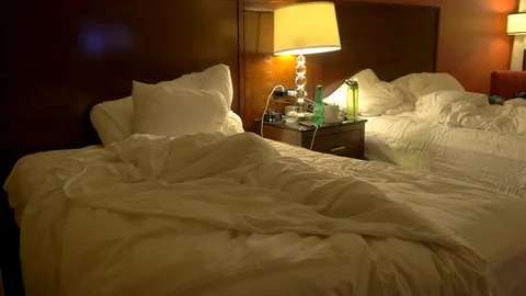 Messy Empty Hotel Beds at Night. Stock Footage 82429704