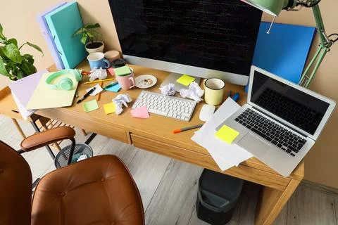 Messy home office desk with computer laptop and stationery overworked remote  Stock Photos