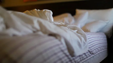 Messy Hotel Bed In Low Light Видео 38216750
