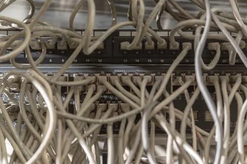 Messy network cabling at switch router cabinet. Stock Photos