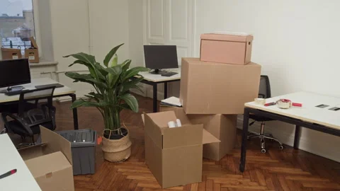 Messy Office with Cardboard Boxes, Tables with Computers and Chairs Stock Footage 330450735