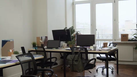 Messy Office Workspace with Computers, Papers, Tables and Chairs near Window Stock Footage 330448132