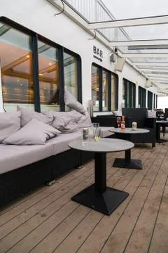 Messy outer deck of a car ferry on the morning with garbage and empty glasses Foto stock