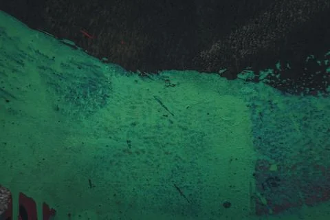 Messy paint strokes and smudges on old black painted wall. Green color drips Stock-Illustration