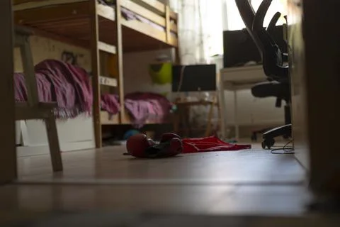 Messy shared bedroom with bunk beds and scattered clothes Stock Photos