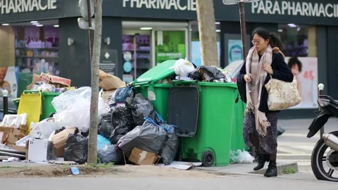 Messy streets with overfull garbage bins during binmen strike in Paris, France Stock Footage 316893248