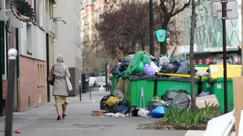 Messy streets with overfull garbage bins during binmen strike in Paris, France Stock Footage 316893260