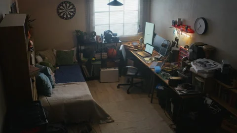 Messy Student Bedroom Featuring Computer Desk with Electronics Stock Footage 338424596