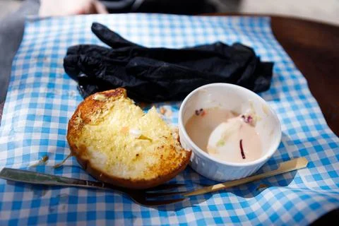 A Messy Table Setting Featuring a Partially Eaten Dish and Utensils on a Blue Stock Photos