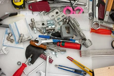 Messy tool desk top view scattered and unorganized work tools no people Stock Photos