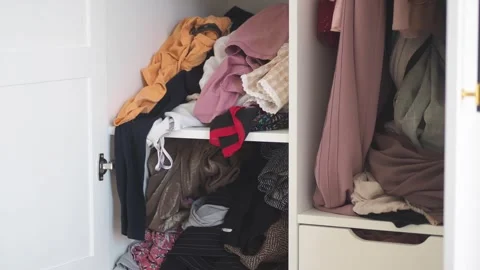 Messy wardrobe full of clothes clothes closet clutter messy disorganized cl.. 動画素材 332886408