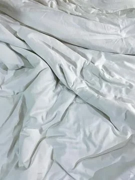 Messy white bed cover as texture background Stock Photos