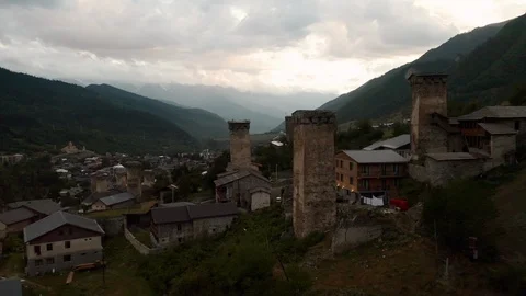 Mestia, Svaneti. Drone flying through the famous Svan towers at sunset Stock Footage 116560971