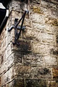 Metal angle bracket on old stone wall Stock Photos