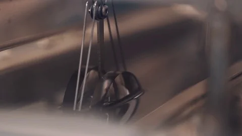Metal automatic machine hook pulling lenses on rode out liquid at manufactory Stock Footage 76570582