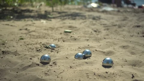 Metal Balls Fall onto Sand. Beach Petanque Game in Sunny Weather. Players metal Stock Footage 346560300