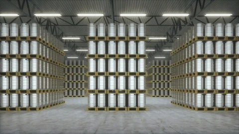 Metal barrels in warehouse. Horizontal camera move between the rows of racks. Видео 113334569