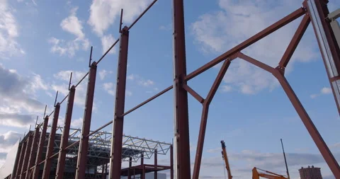 Metal beams of the future factory workshop, against background of flying clouds Stock Footage 161960344