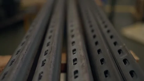 Metal beams line up in workshop setting Stock Footage 346153073