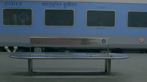 Metal bench and train standing on platform india Stock Footage 228197008