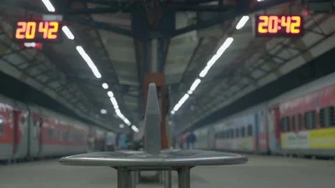 Metal bench and train standing the both side on platform india Stock Footage 228197077