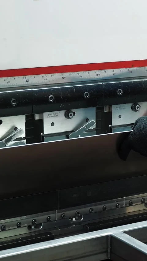 Metal bending. The technician operator is bending metal sheet by cnc control Stock Footage 317315810