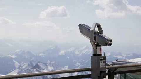 Metal binoculars on a viewing platform, snow covered mountain landscape Stock Footage 168079841