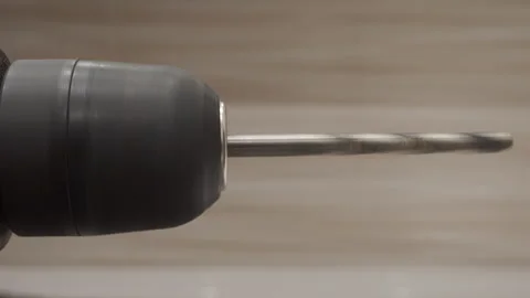 The metal bit of the plastic electric drill rotates at a varying speed. Stock Footage 320889416