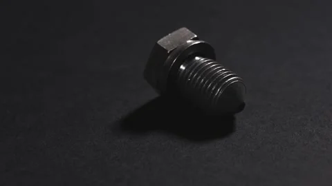 Metal bolt on dark background. Chromed screw bolt. Steel bolt. Nuts and bolts. T Stock Footage 302168577