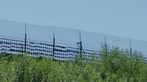 Metal border security fence with circular pattern and wire, close up tracking Stock Footage 340892970
