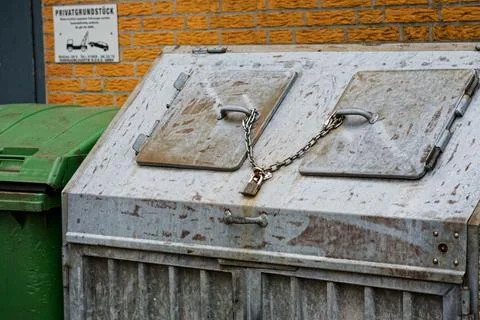 Metal bottle garbage container with chained lids and secure lock Stock Photos