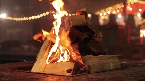 Metal brazier with a hole in the middle for burning wood, open air fire at night Stock Footage 258581150