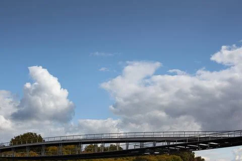 Metal bridge below the clouds Stock Photos