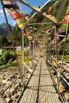 Metal bridge with prayer flags between Salleri and Lukla, Mount Everest Basec Stock Photos